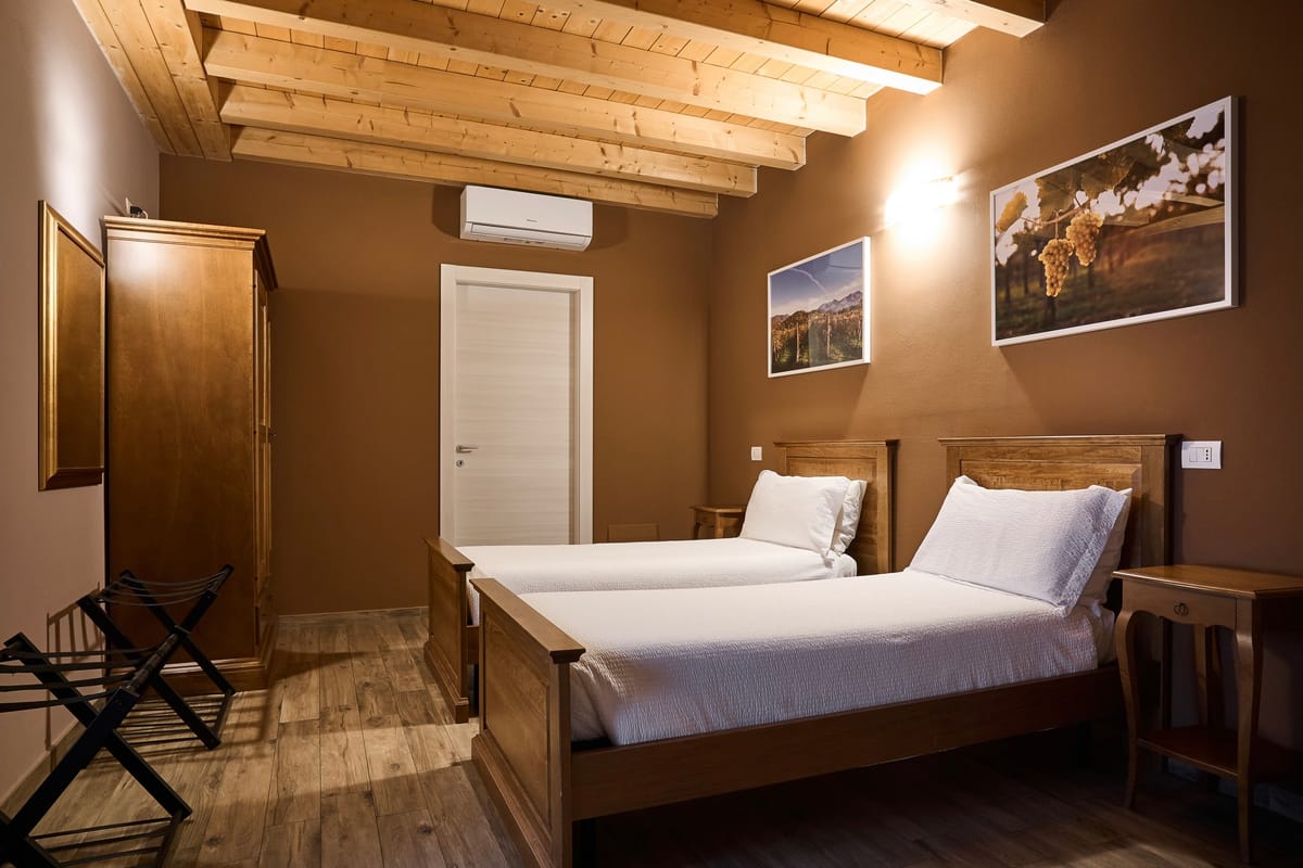 Room with two single beds and exposed beams